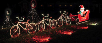 Santa in sleigh with lighted bicycles instead of reindeer